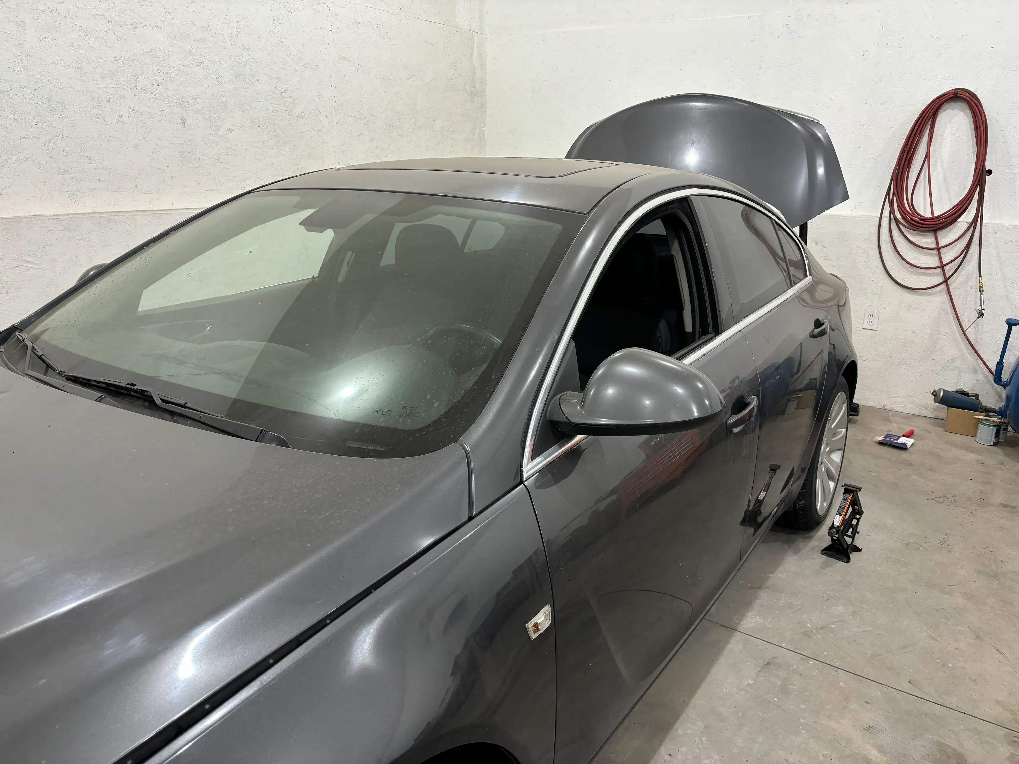 Sedan with rear quarter panel dent before paintless dent repair