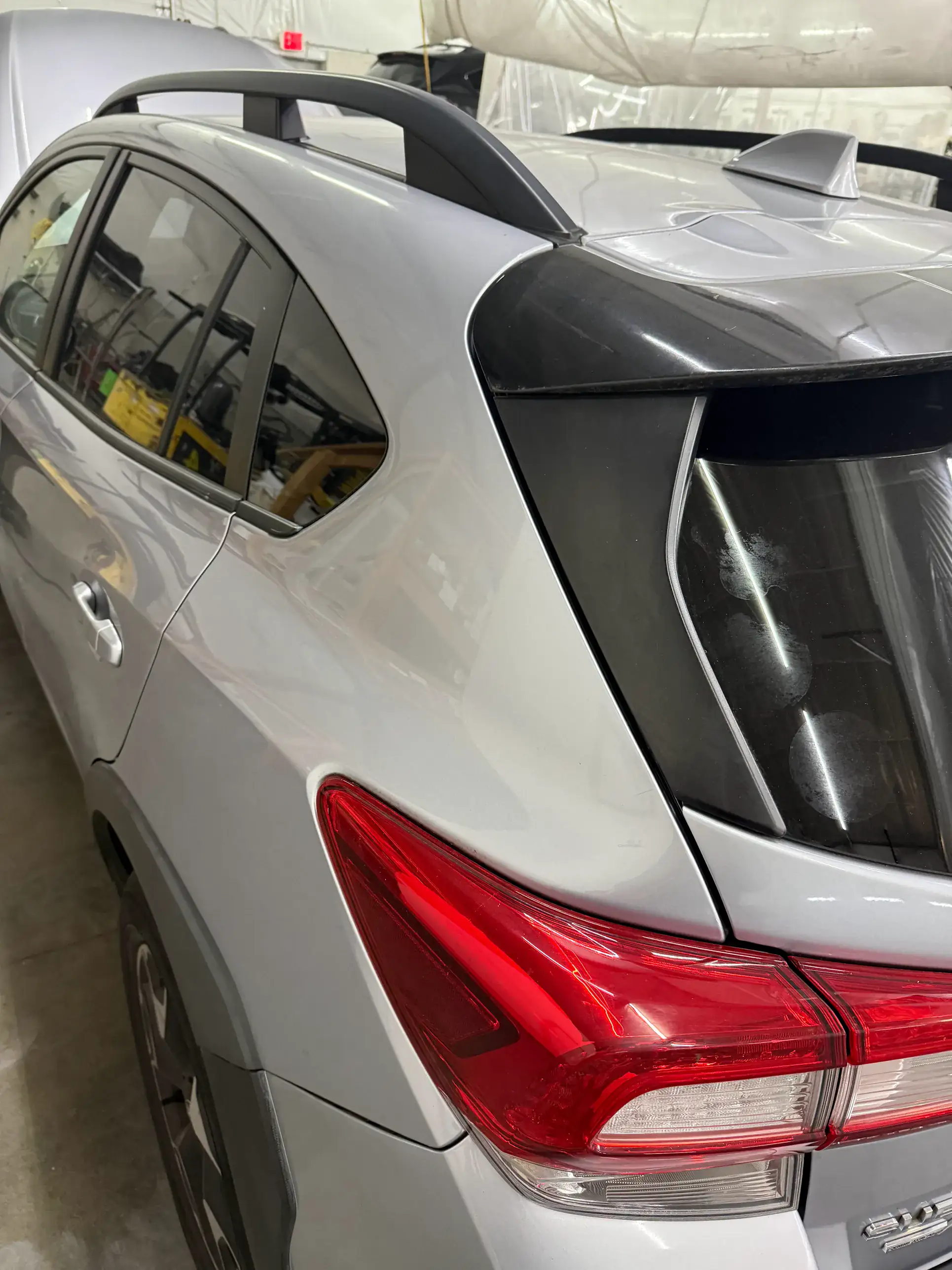 Silver SUV after dent removal — clean rear quarter panel
